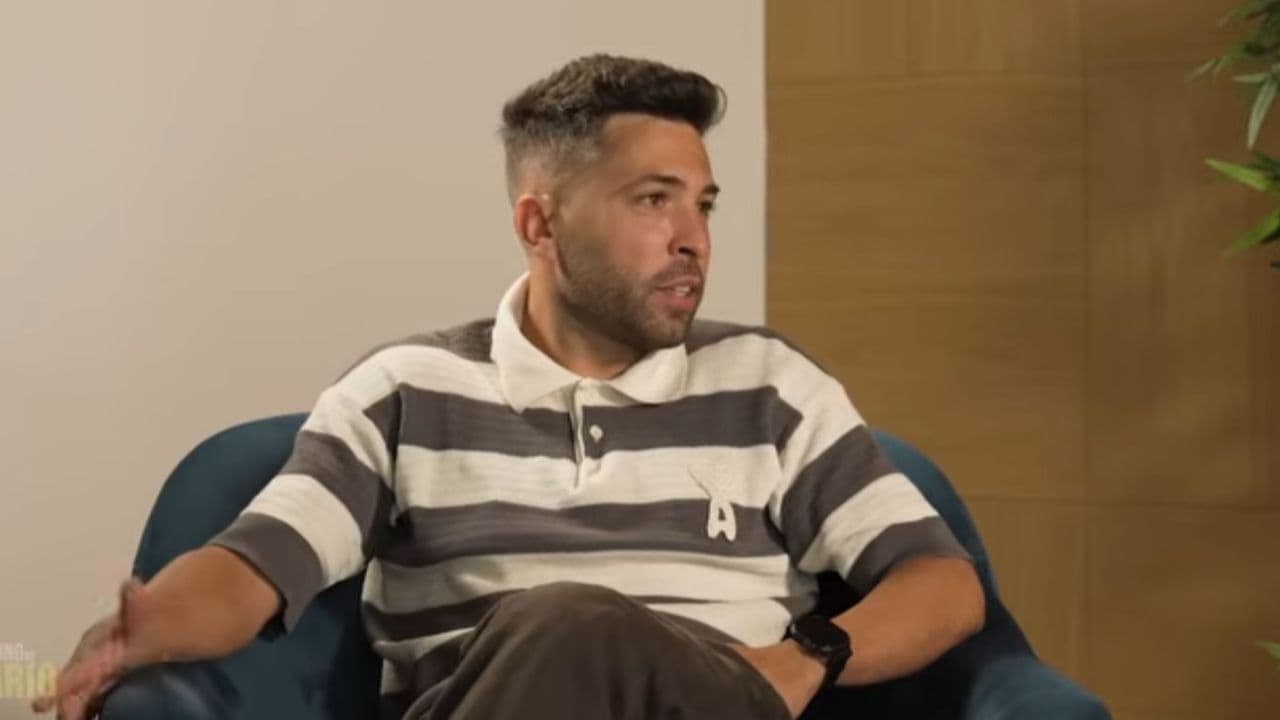 Person speaking during an interview on a couch