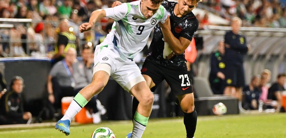 Two players contesting the ball during soccer match