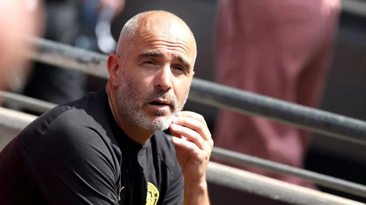 Coach observing from the sidelines during match