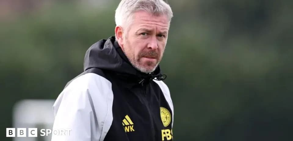 Manager observing training session on the pitch