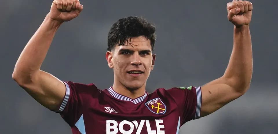 Player celebrating with raised fists in West Ham kit