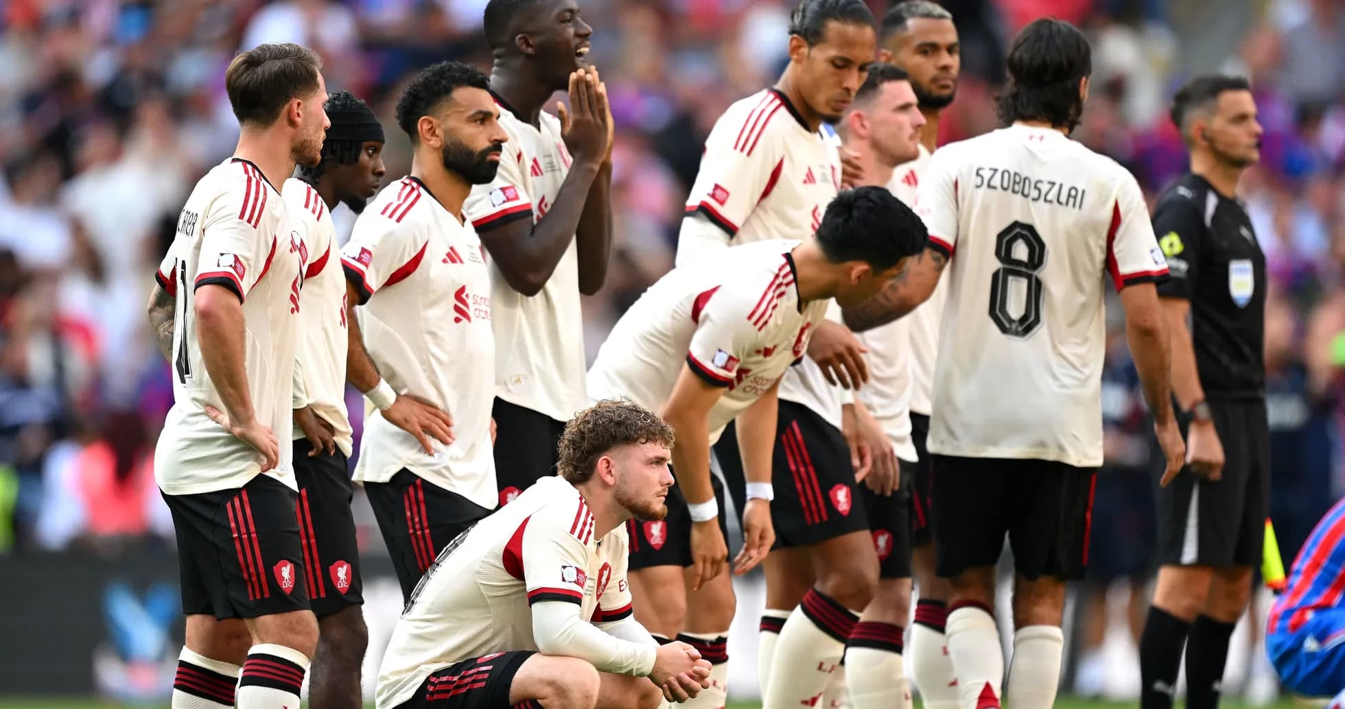 Players in white jerseys preparing for a free kick