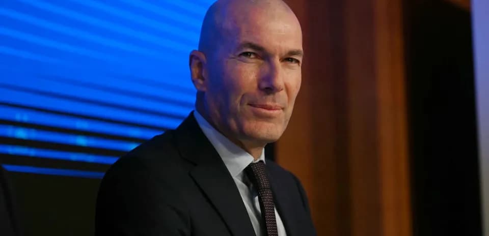 Bald man in suit at press conference