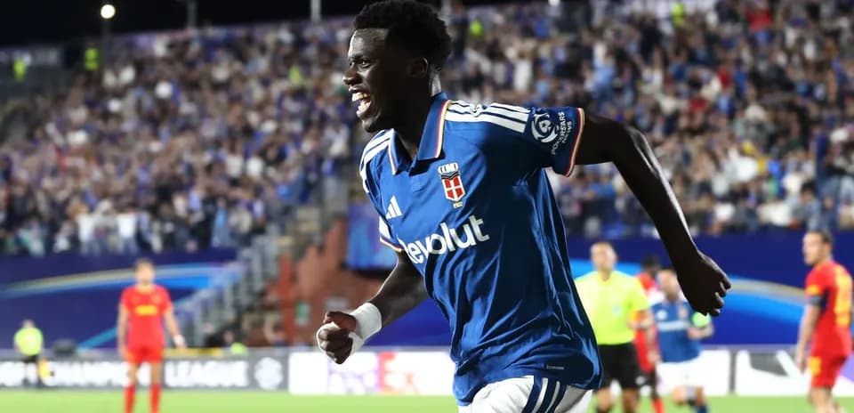 Player celebrating a goal with fans in background