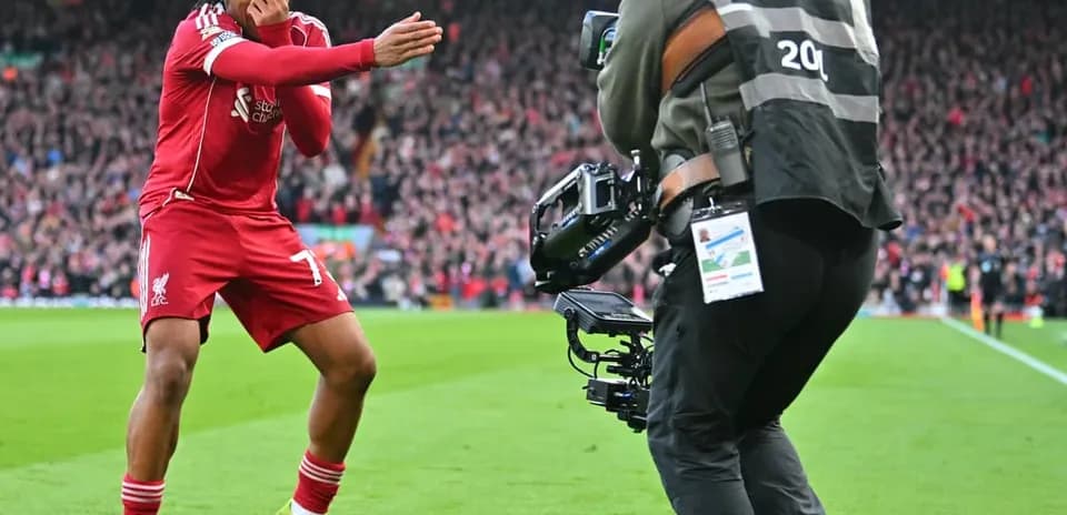 Liverpool player celebrating in front of photographer