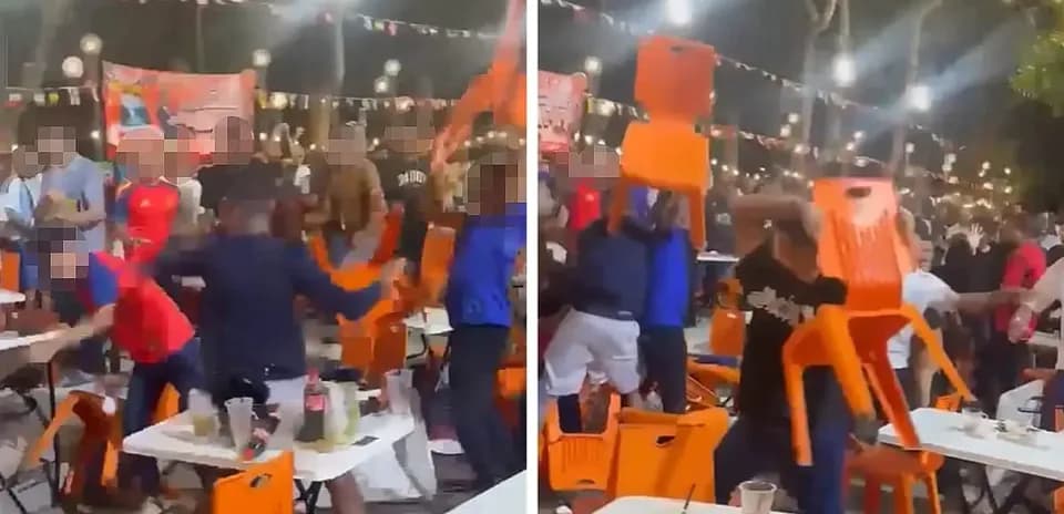 Crowd throwing chairs during a celebration event