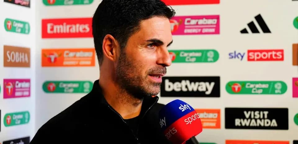 Manager speaking during press conference with microphone