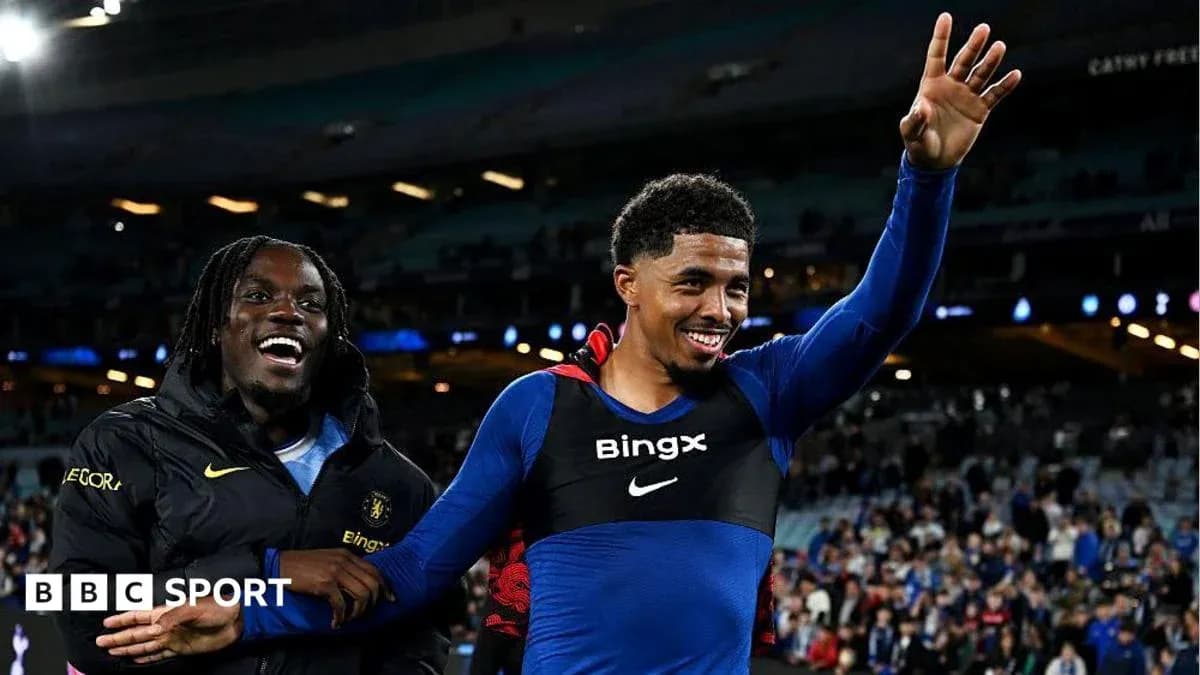 Two players celebrating on the pitch after match
