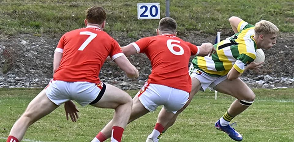 Player in striped jersey evading two defenders