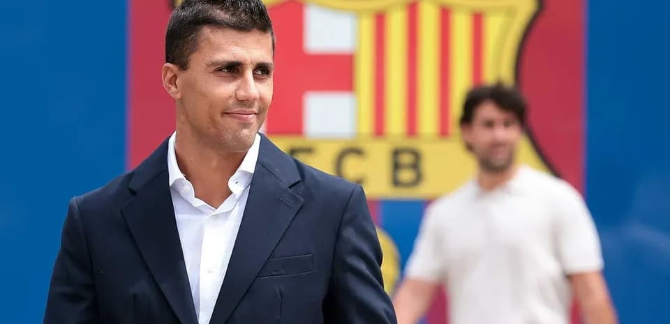New signing posing in front of FC Barcelona logo