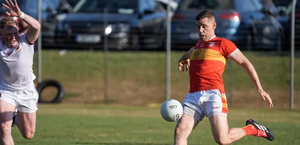 Player kicking a Gaelic football during match