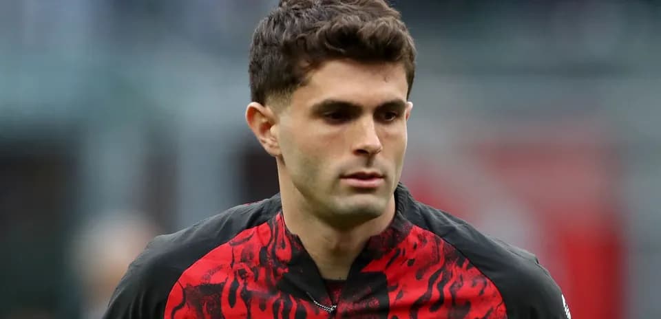 Player in red and black jersey walking on field