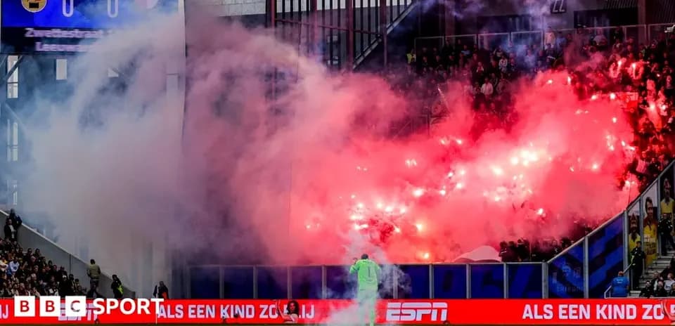 Fans creating smoke with flares during match