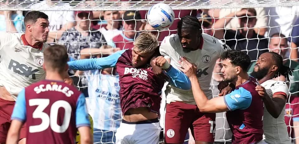Players contesting a header near the goal line