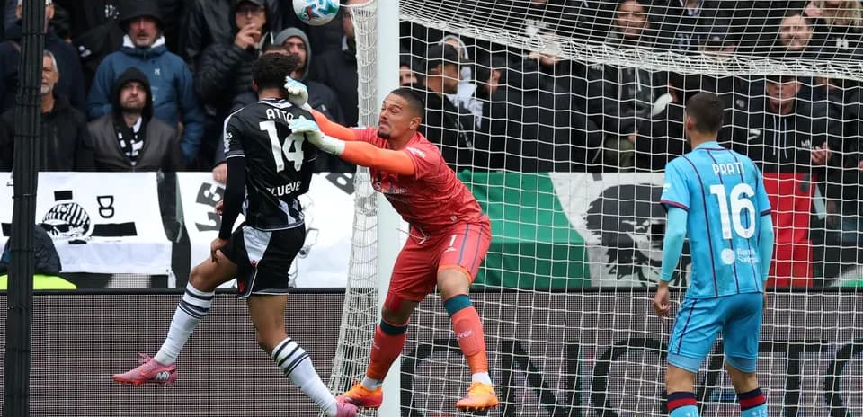 Goalkeeper challenging player during Cagliari match