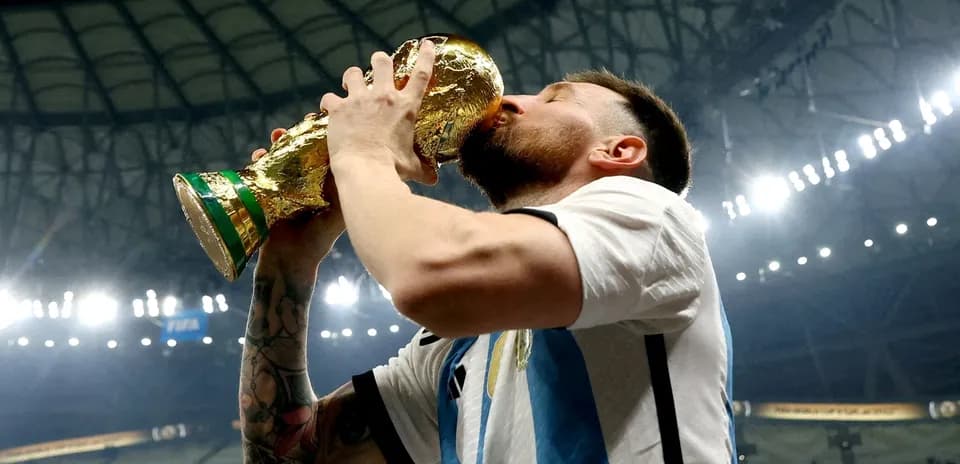 Player celebrating by kissing World Cup trophy