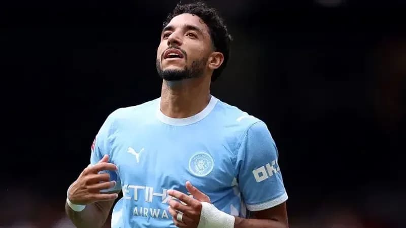 Player celebrating in Manchester City kit on pitch