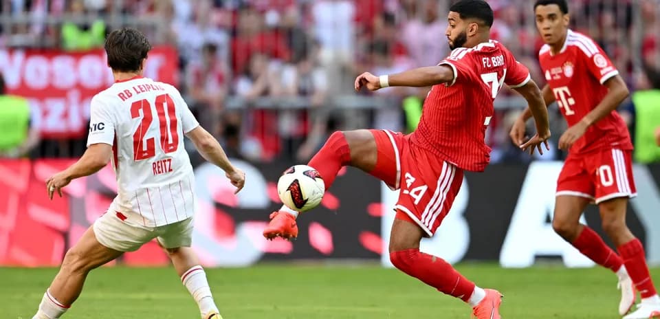 FC Bayern player kicking ball against RB Leipzig player