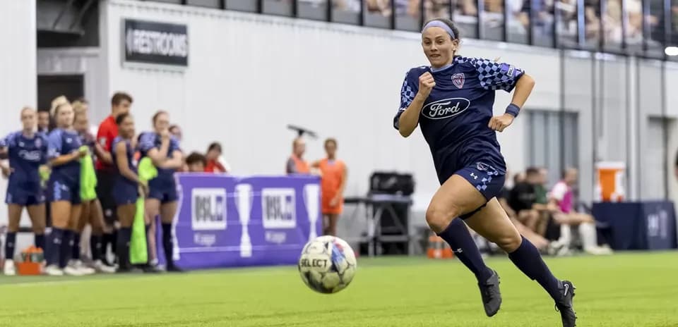Player sprinting with ball during USL match
