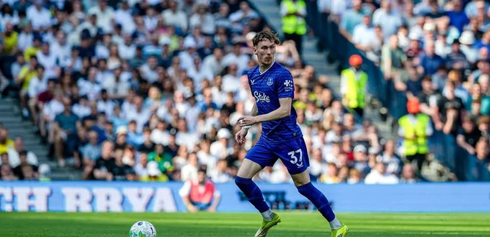 Player in blue kit running on the pitch