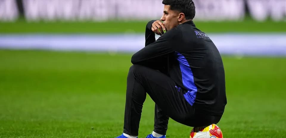 Player sitting on the pitch with a ball