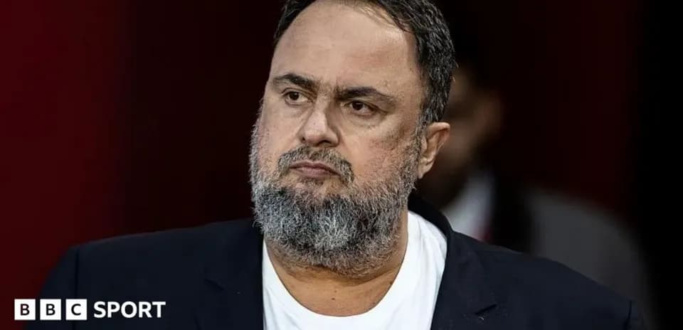 Man with beard wearing a black suit jacket