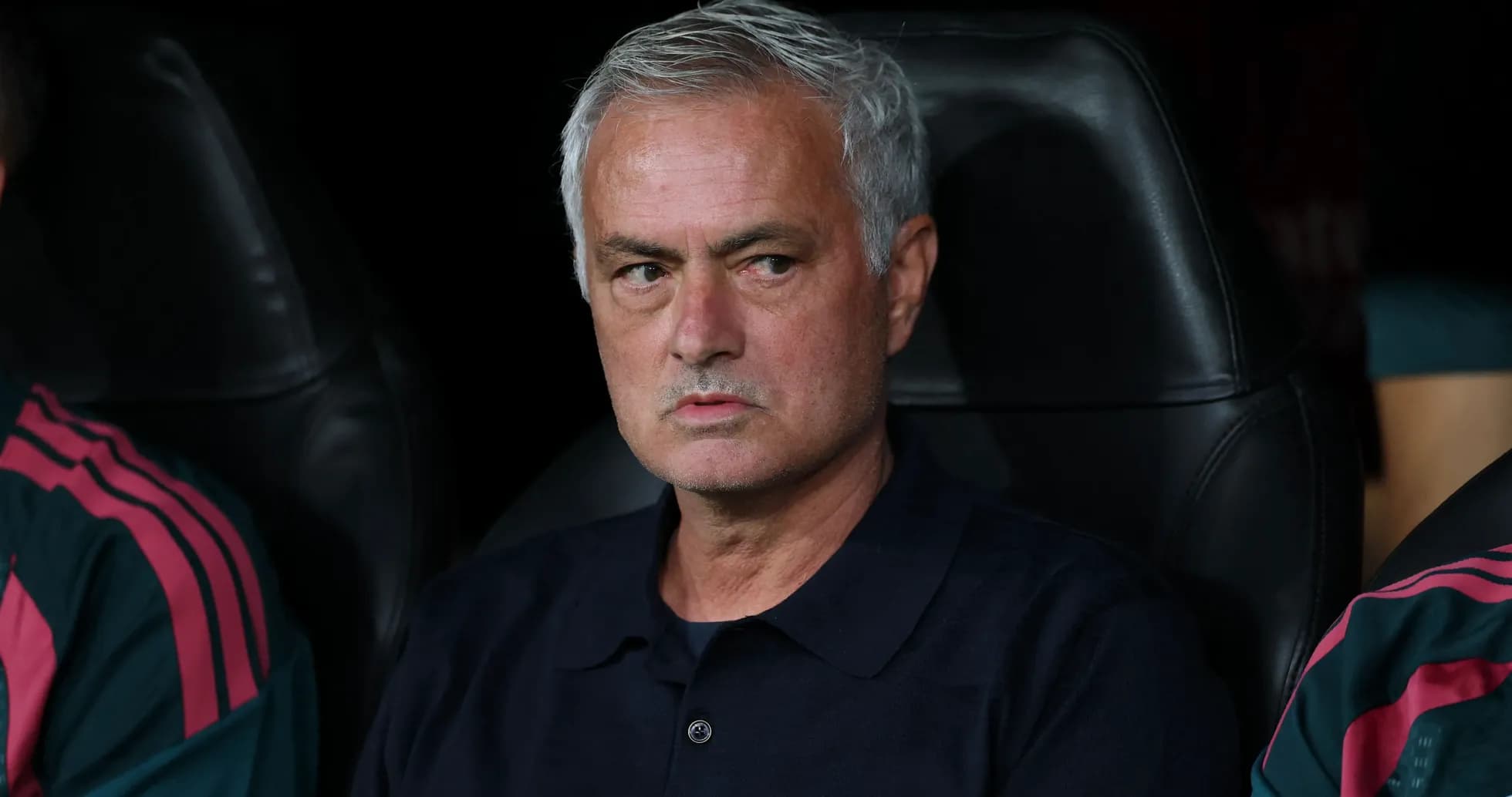 Manager sitting on bench during a match