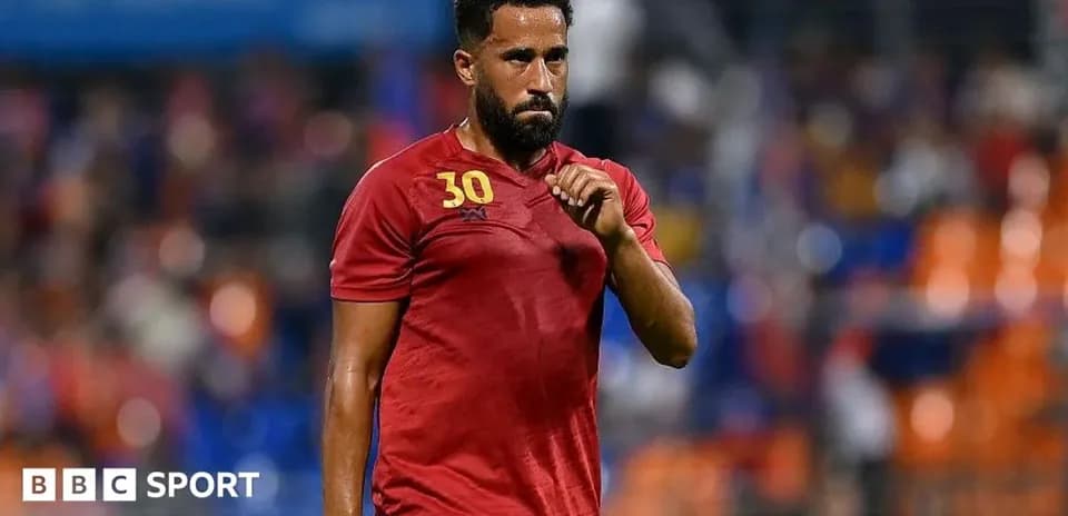 Player in red jersey walking off the field