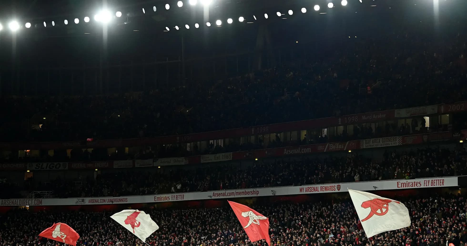 Fans waving flags at Arsenal stadium during match