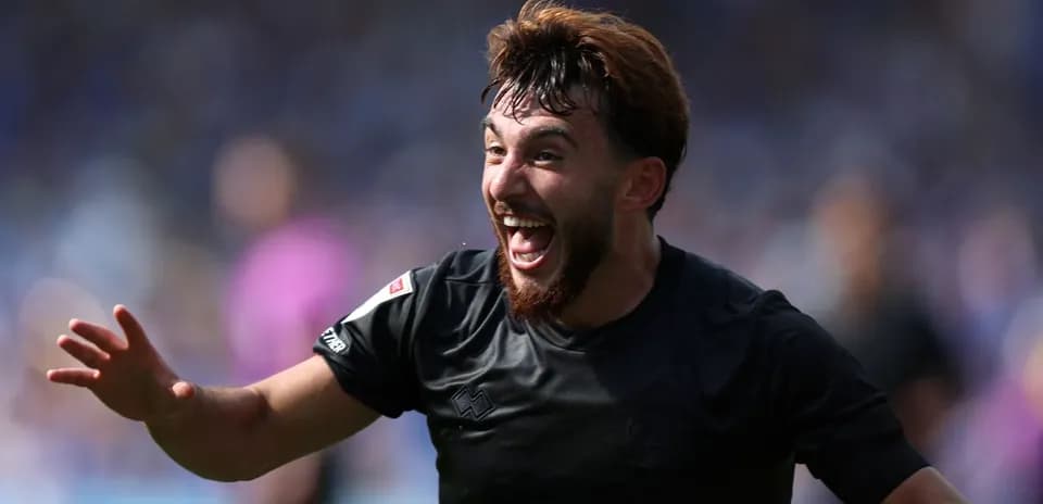 Player celebrating a goal with outstretched hand