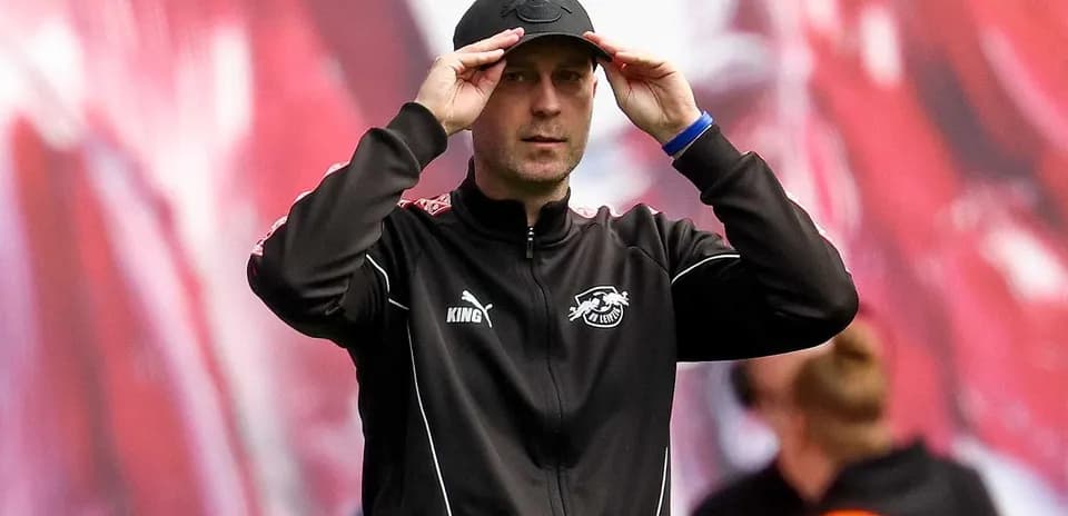 Coach adjusting cap during match on the sidelines