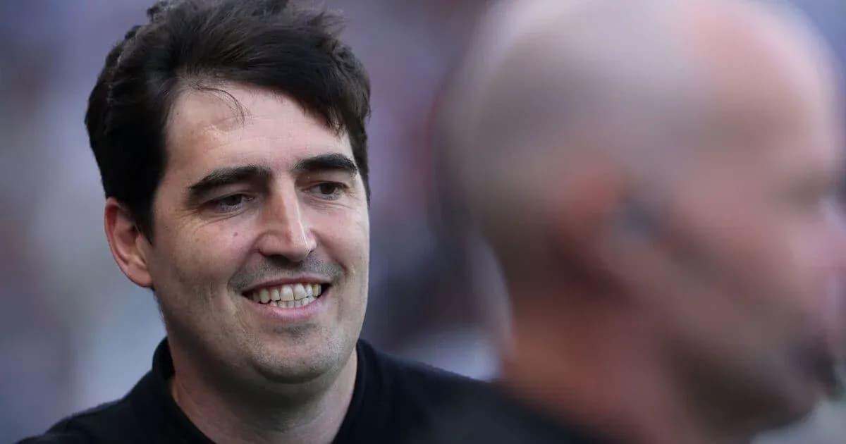Man smiling during an event with another person