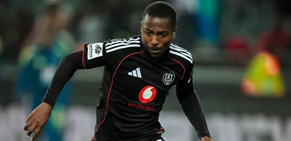 Player running during a match in black kit