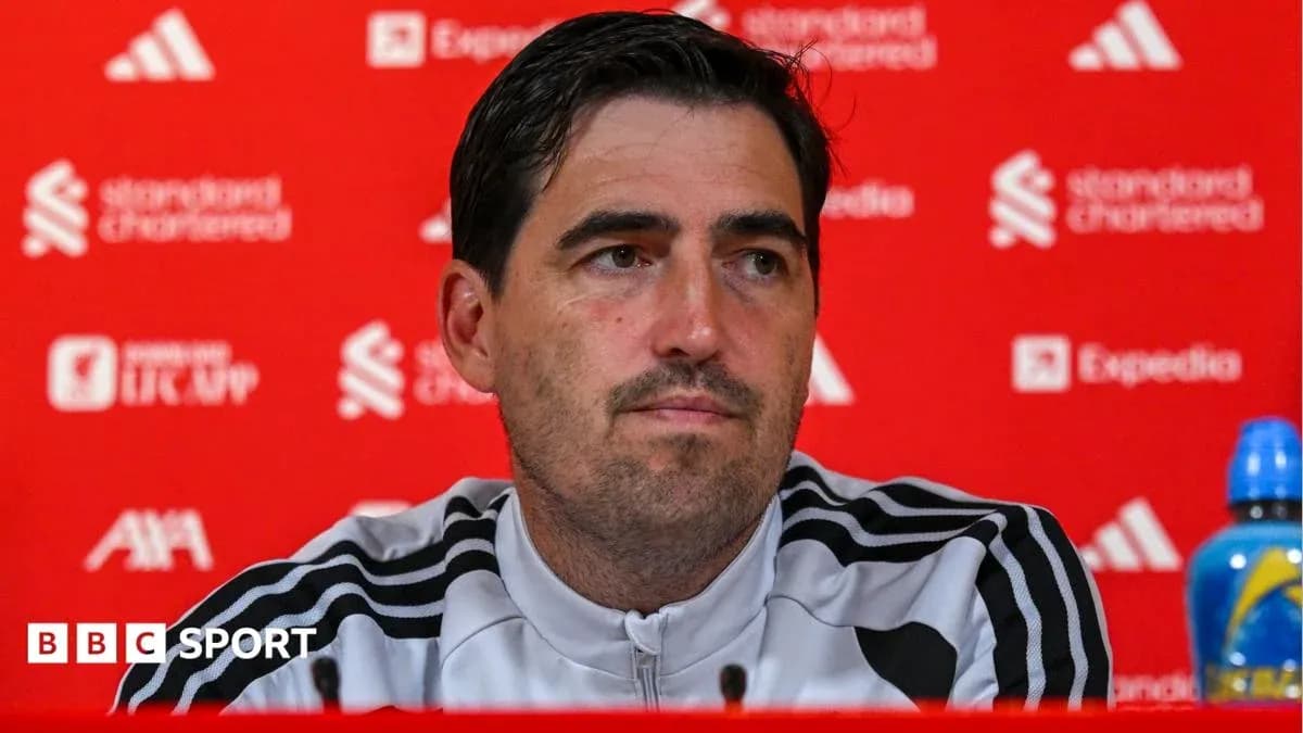 Manager speaking at press conference with sponsor backdrop