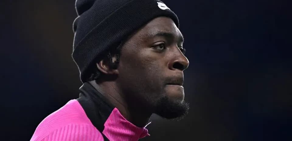 Athlete in pink training gear wearing a black beanie