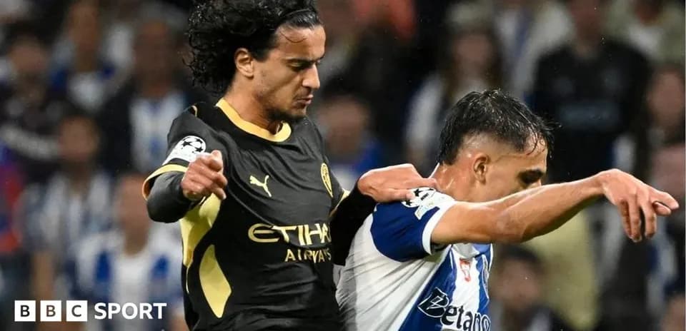 Two players in a competitive tackle during match