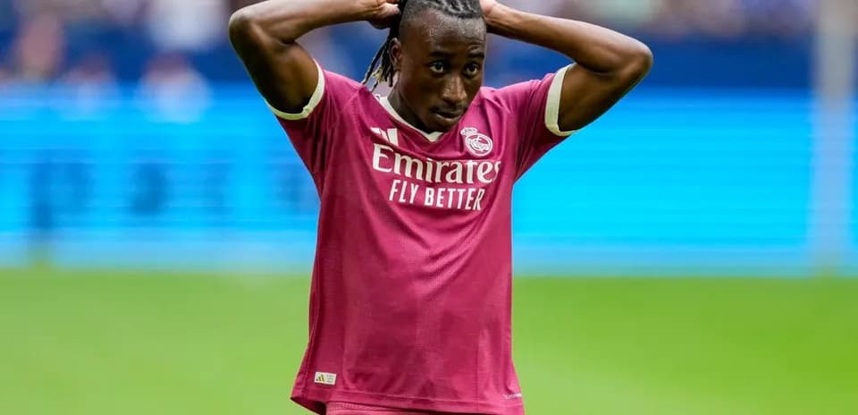 Player in pink jersey holding head during match