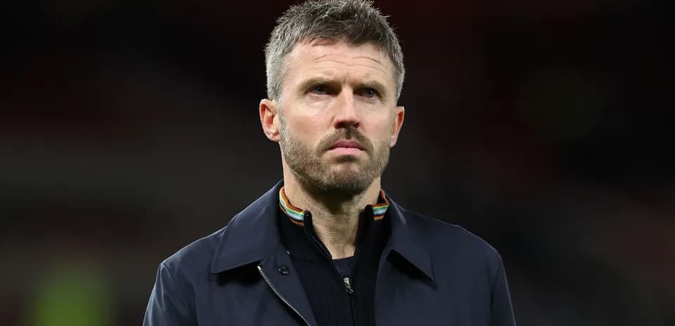 Coach standing on the pitch during match