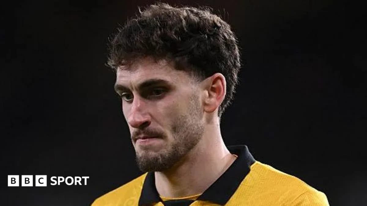 Player in yellow jersey looking down after match