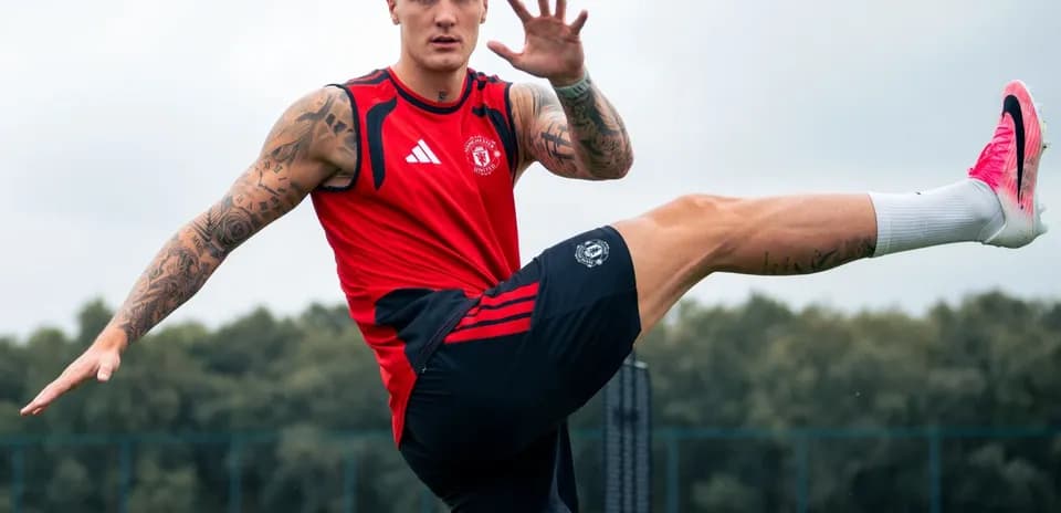 Player training with high kick on football pitch