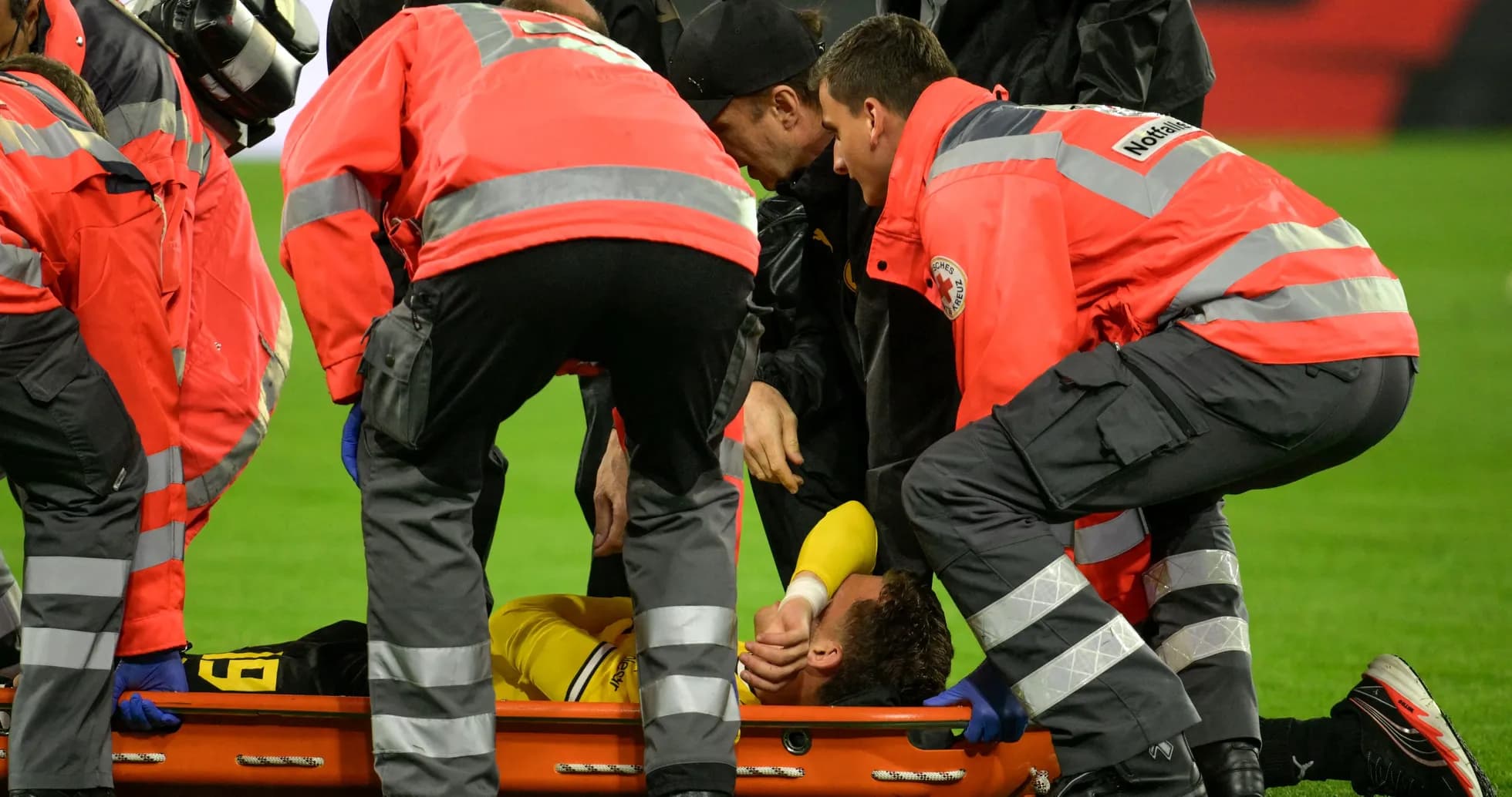 Medical team attending to injured player on stretcher