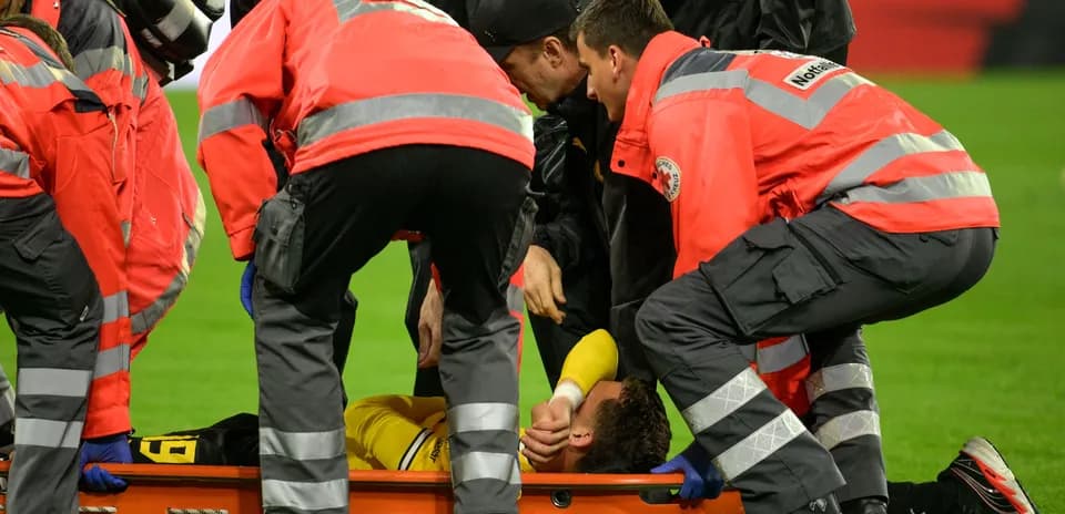 Medical team attending to injured player on stretcher