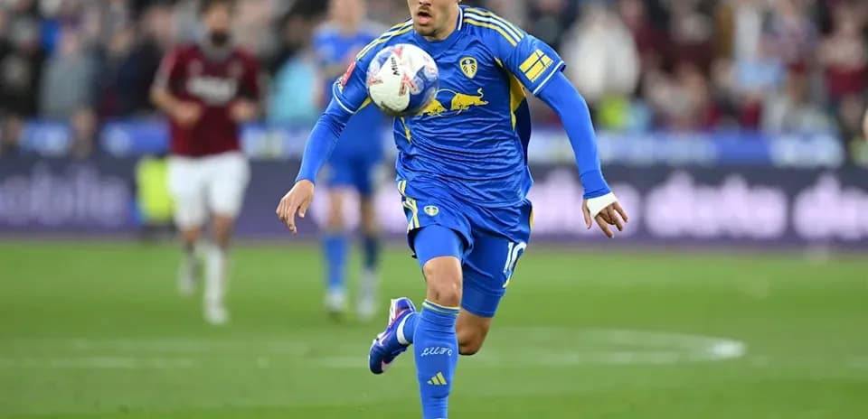 Player in blue kit controlling the ball on field