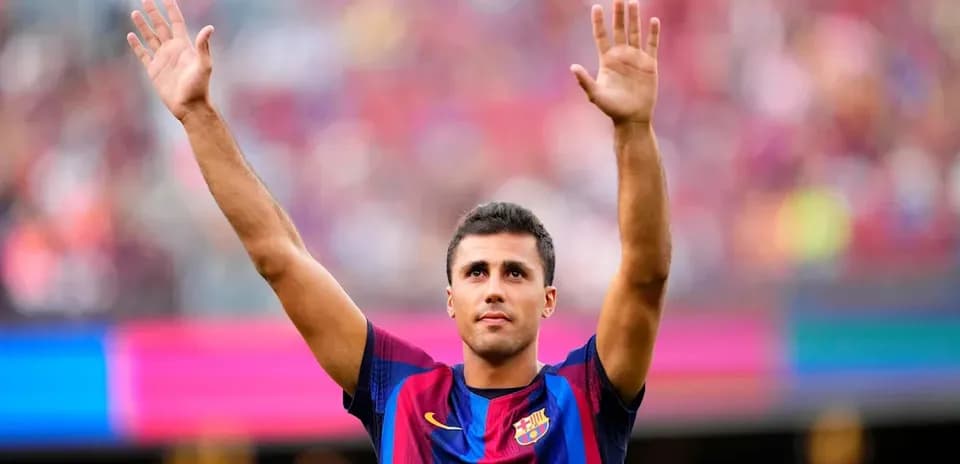 Player waving to fans during match at Camp Nou