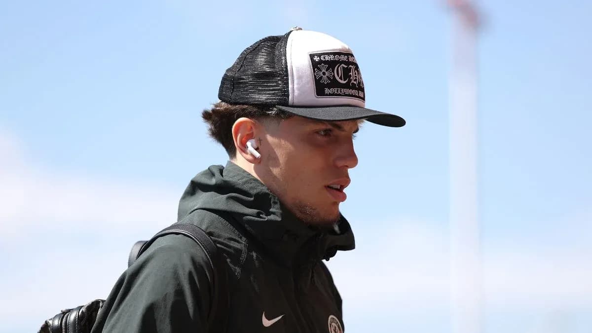 Player walking with hat and earbuds outdoors