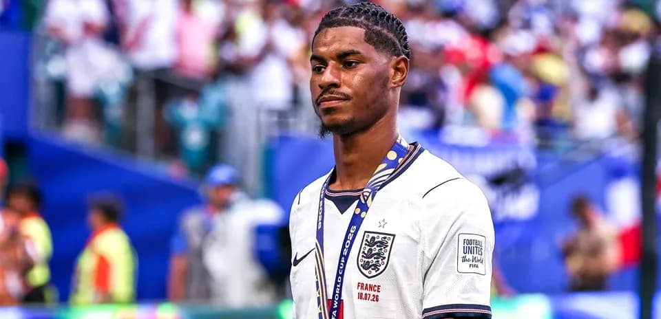 Player in England jersey with medal on field