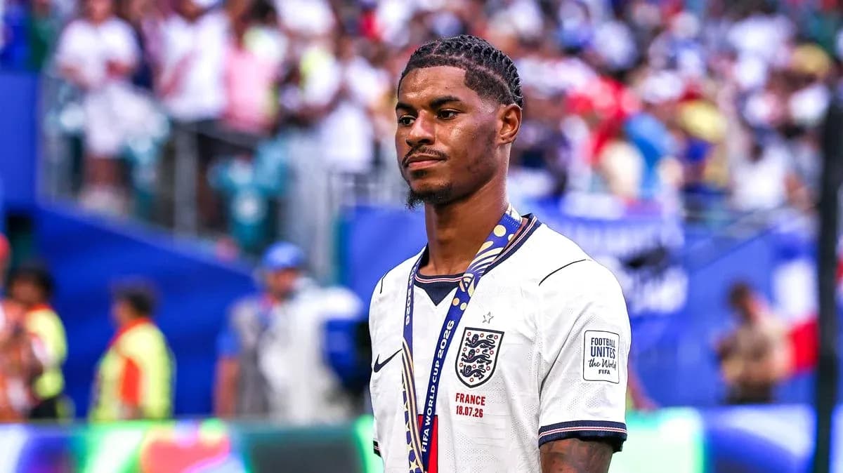 Player in England jersey with medal on field