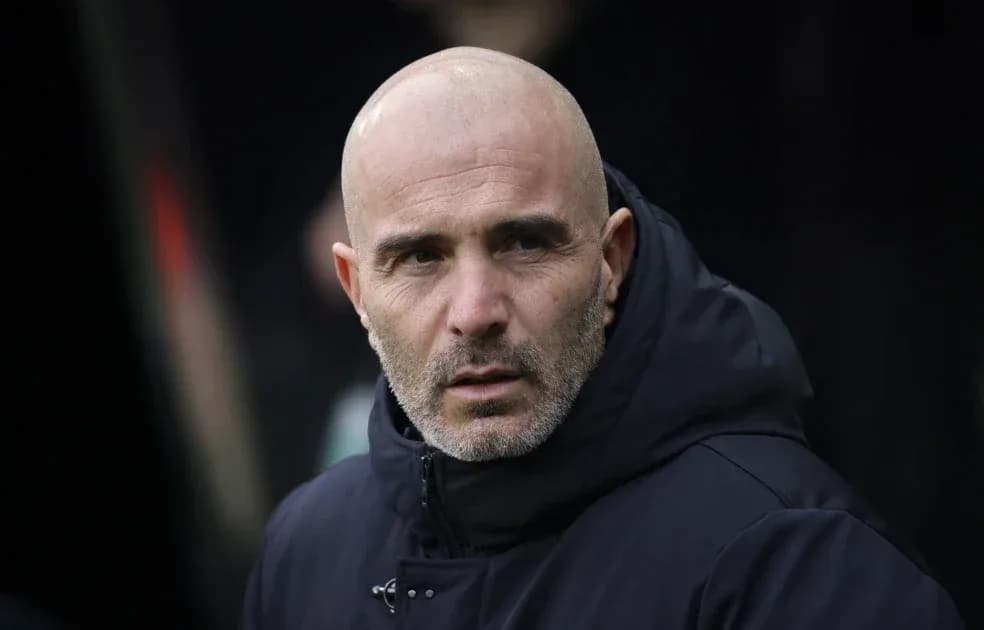 Coach observing from the sidelines during match
