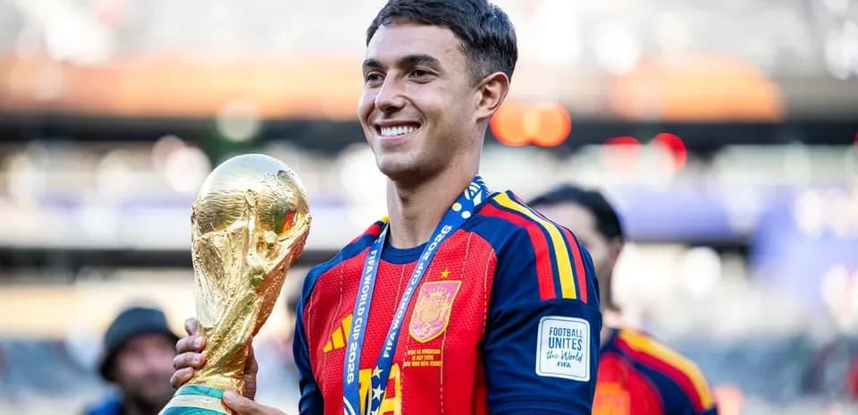 Player holding FIFA World Cup trophy in stadium