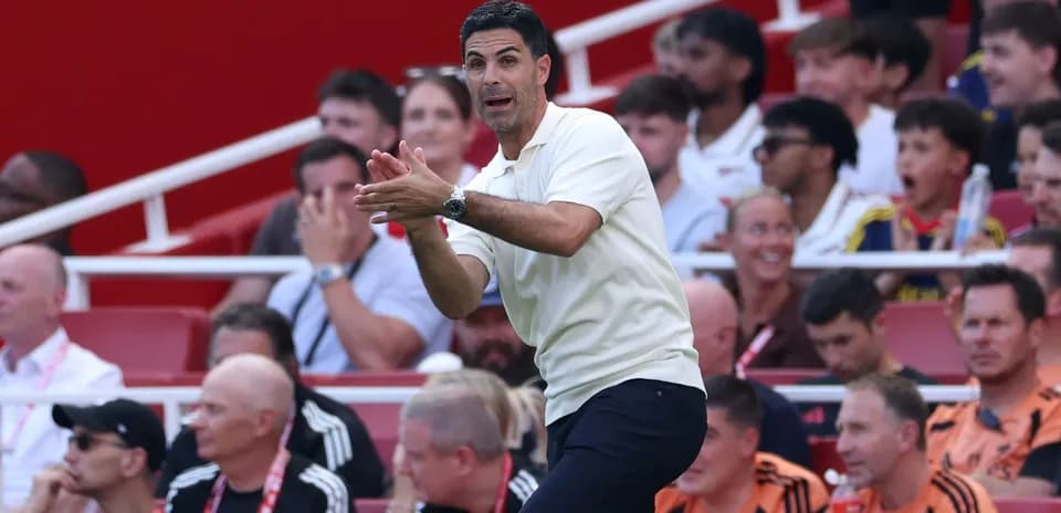Coach instructing players from the sidelines during match